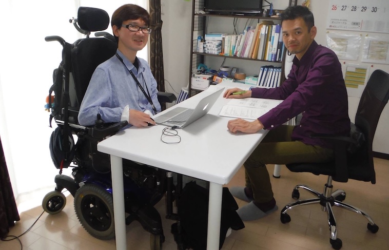 【写真】白いデスクを挟んで向かい合って座っているわたなべさんとにしださん